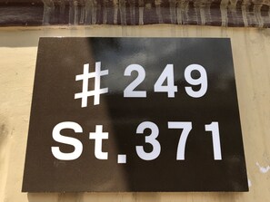 A black sign with white text reading "# 249 St. 371".