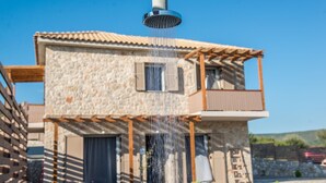 A stone building with a water feature. - Roggaki Ionian Villas (Aktio-Vonitsa)