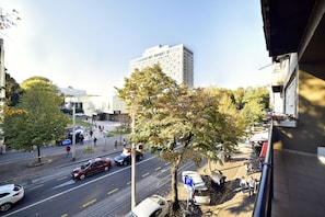 A street view with a building labeled "WESTIN" in the background, a tree-lined sidewalk, and parked cars. - Vla Vla Apartments (Zagreb)