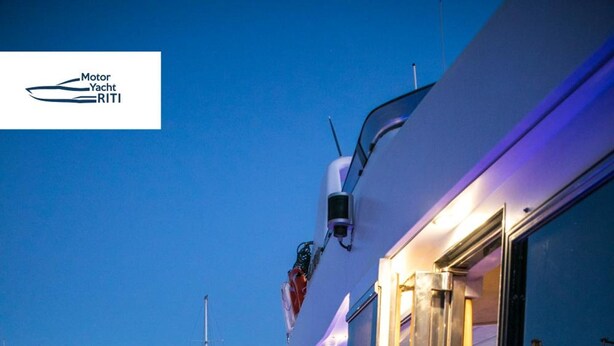 A yacht docked at a marina with a view of other boats and buildings in the background. - Riti Yacht (Kalkara)