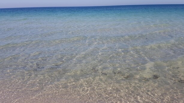 A clear view of a beach with shallow water and a distant horizon. - Dar Lebharr (Kelibia)