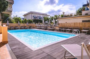 Seasonal outdoor pool, open 9:30 AM to 6:30 PM, pool umbrellas