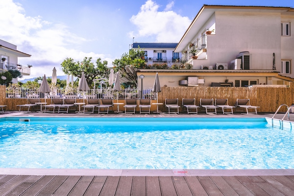Seasonal outdoor pool, open 9:30 AM to 6:30 PM, pool umbrellas