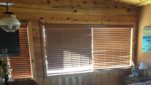 A wooden cabin room with a bed, a desk, and a window with blinds. - Off the Grid, secluded, Hamm's Hideaway (quemado)