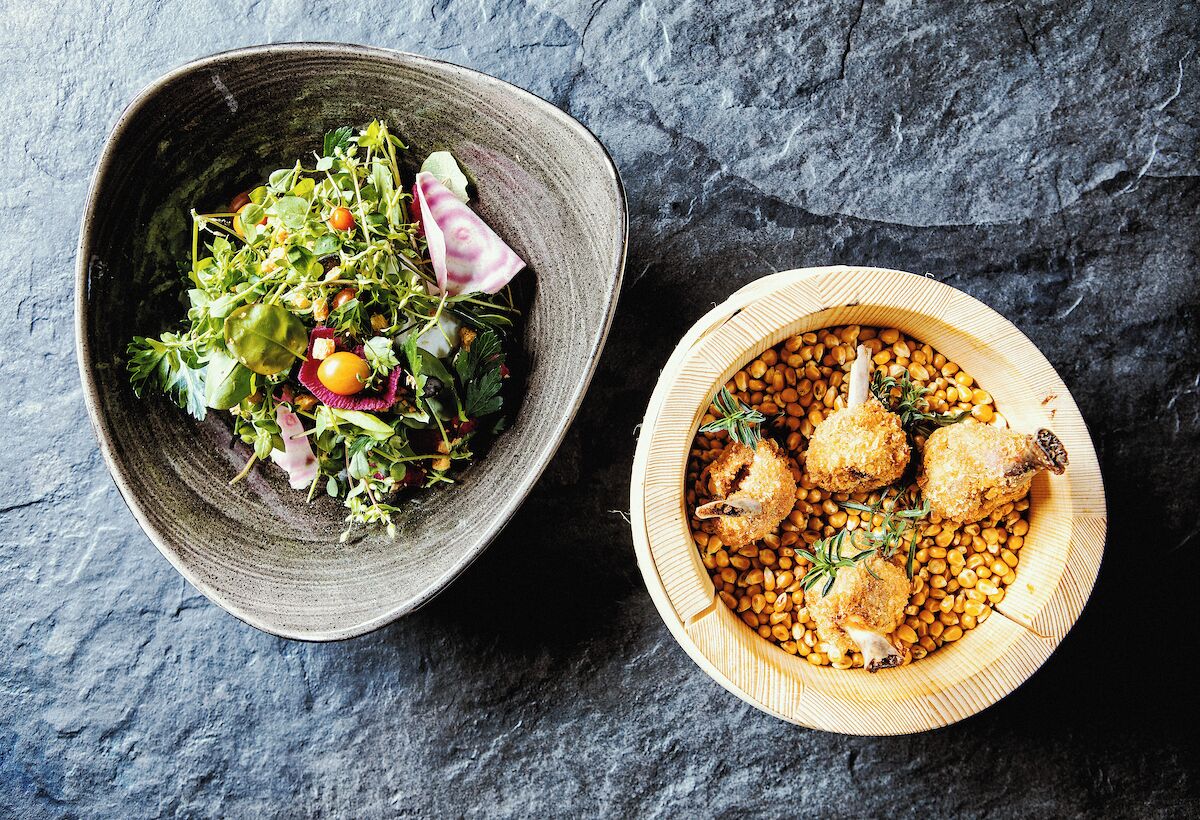 Two bowls of food on a textured surface.