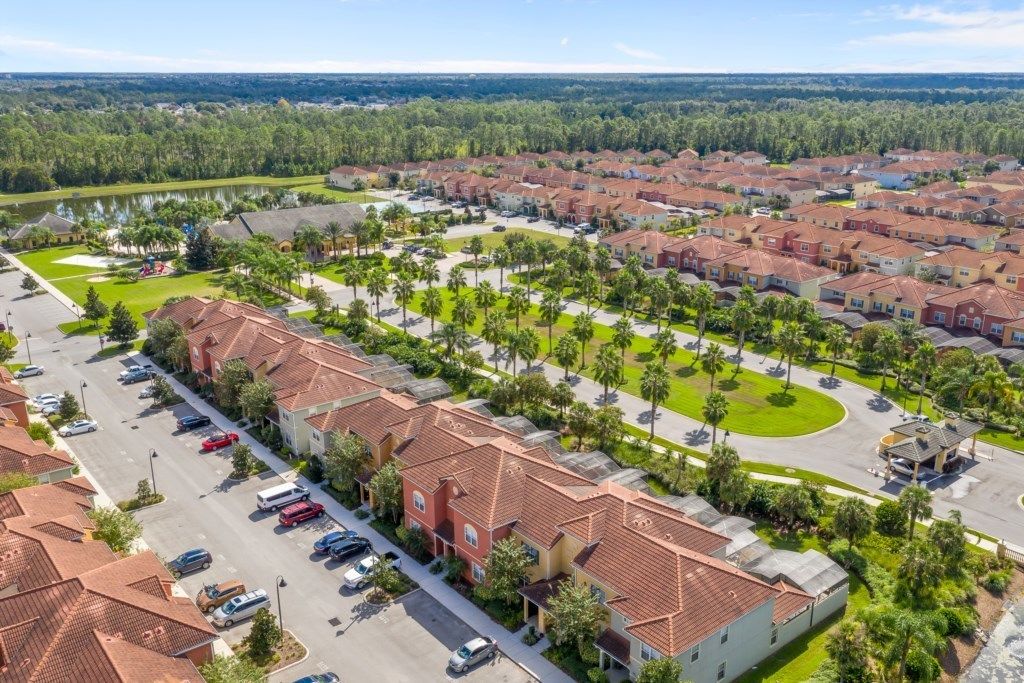 A residential area with multiple two-story houses, a central green space, and a parking lot.