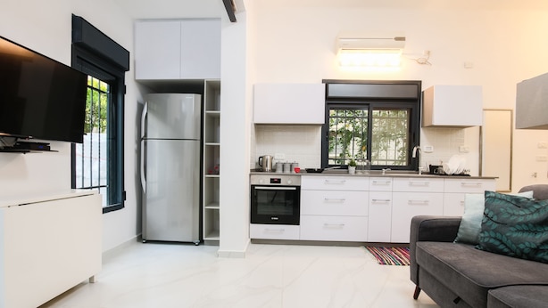City Apartment, Garden View | Living area | Flat-screen TV - 1 BR with Patio in City Center by FeelHome (Tel Aviv)