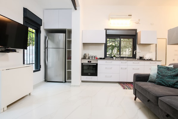 City Apartment, Garden View | Living area | Flat-screen TV - 1 BR with Patio in City Center by FeelHome (Tel Aviv)