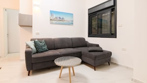 City Apartment, Garden View | Living area | Flat-screen TV - 1 BR with Patio in City Center by FeelHome (Tel Aviv)
