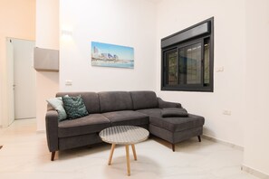 City Apartment, Garden View | Living area | Flat-screen TV - 1 BR with Patio in City Center by FeelHome (Tel Aviv)