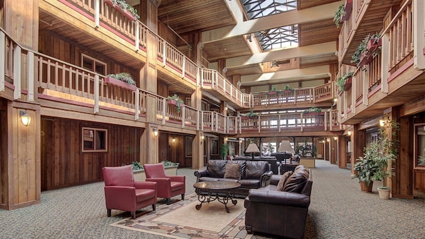 A spacious lobby with a high ceiling, wooden architecture, and multiple balconies. - 3bd_atrium_302 (Breckenridge)