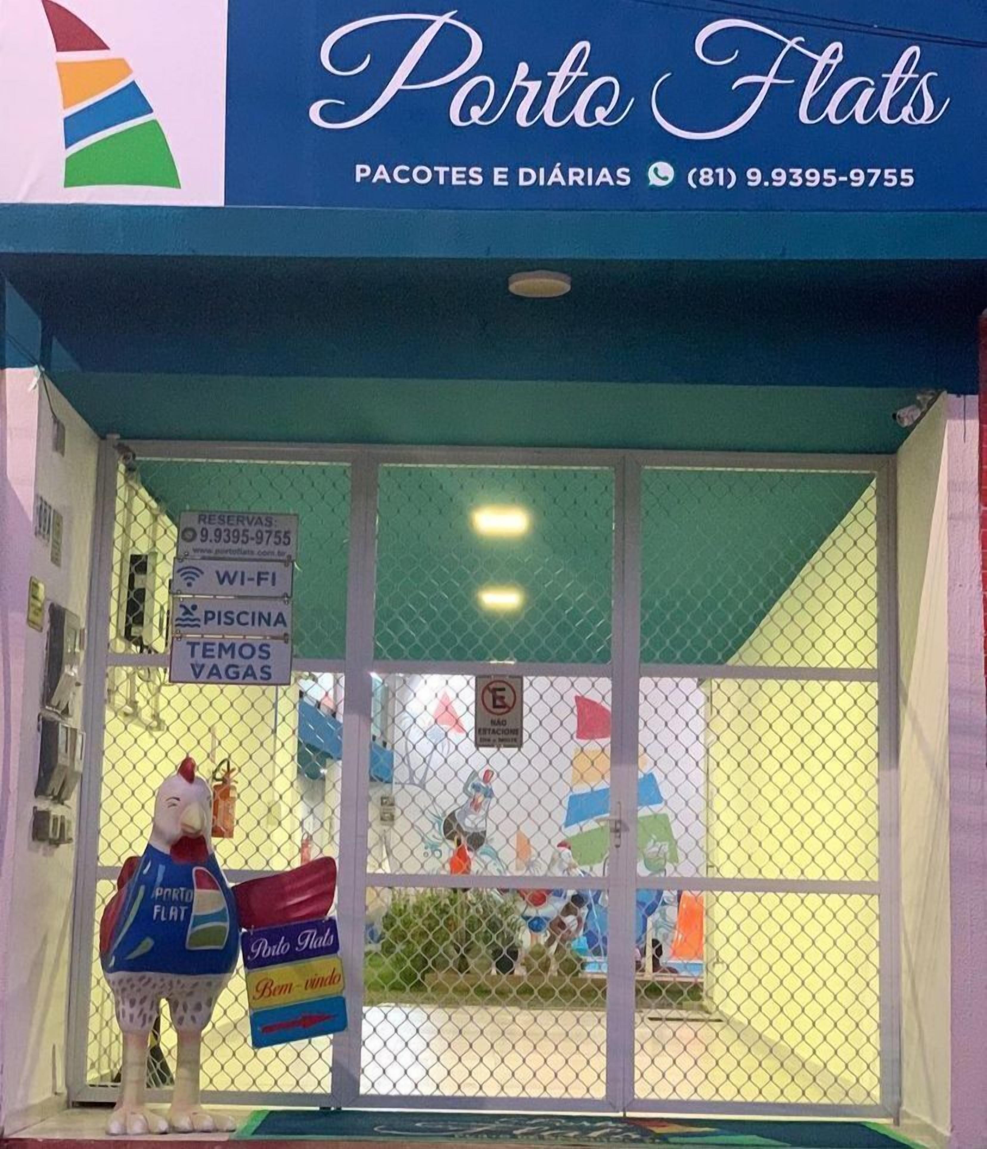 A storefront with a sign for 'Porto Flats' offering packages and daily rates.