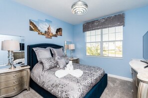 A bedroom with a bed, bedside tables, a dresser, a large window with blinds, and a ceiling light fixture. - 5BR Pool Home in Storey Lake by SHV-4817 (Kissimmee)