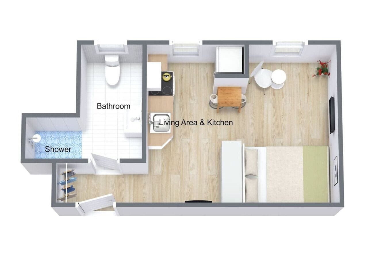 Plànol d'una habitació d'hotel amb bany, dutxa, zona de estar i cuina.