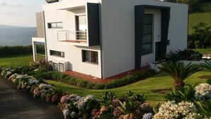 A modern two-story house with a balcony, large windows, and a view of the sea. - Azores Beach Home for adults/children, 3 bed.2 bath, First Fl., 3534/AL (Horta, Azores)
