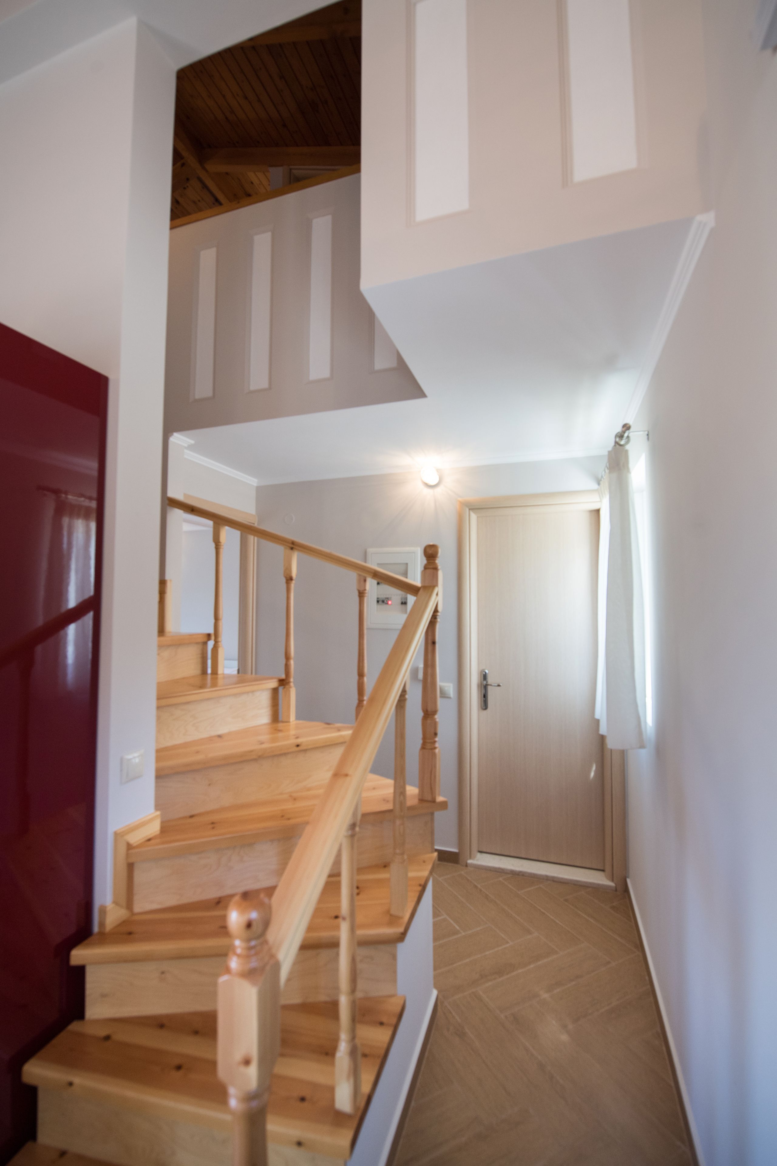 A staircase with wooden railings leading to a landing.