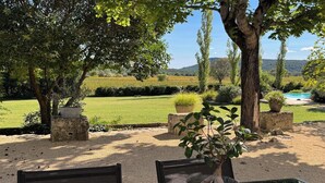 A garden with a pool, outdoor seating, and a view of the countryside. - Loft "Reve d'Evan", design apartment - terrace & spa just for 2 (Carnas)