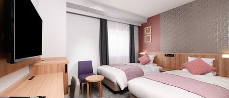 A hotel room with two beds, a TV, a desk, and a chair.