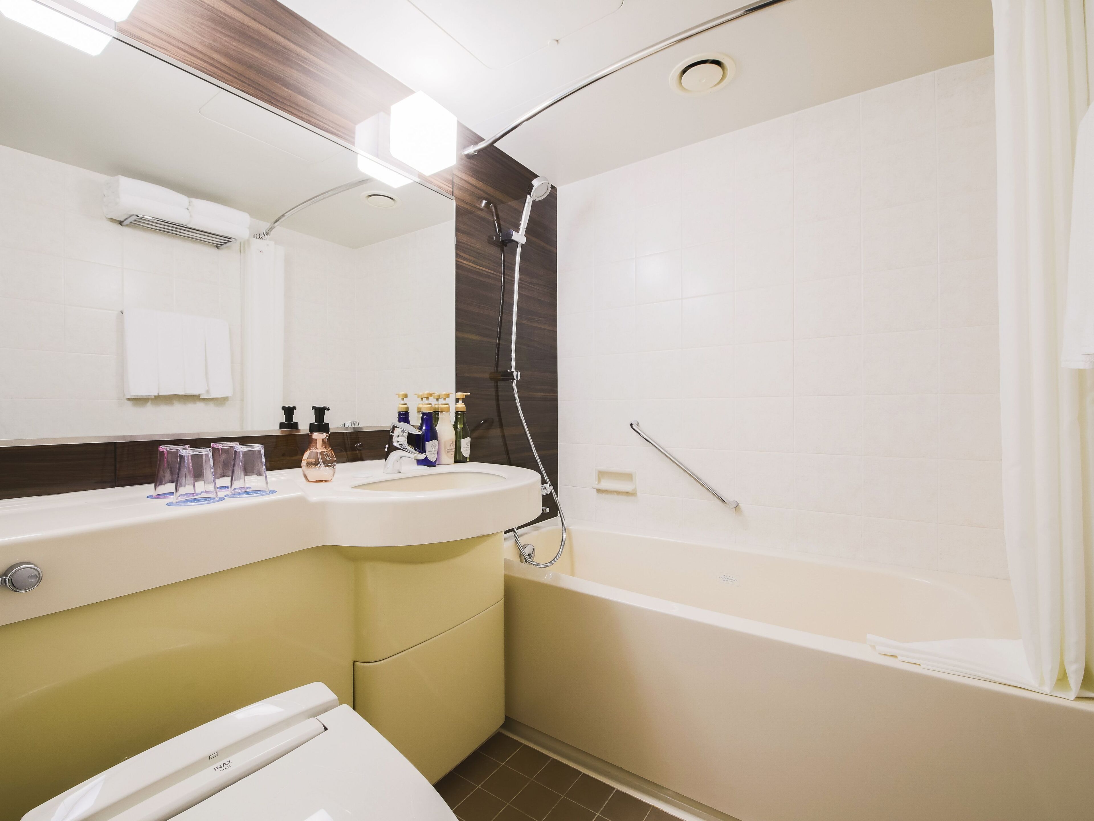 Une salle de bain moderne avec un lavabo, un miroir et une douche.