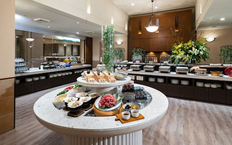 A buffet setup with various food items and a central serving area.