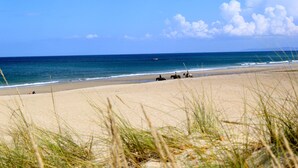 A beach with horses and riders, clear sky, and ocean. - Unique oceanfront retreat with fantastic views of the wild natural space (Carballo)