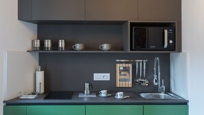 A modern kitchen with a microwave, coffee maker, and a knife block on the counter. - Suite Sant 'Agostino behind the cathedral (Palermo)