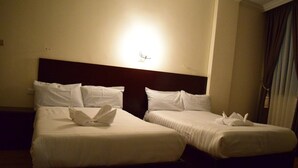 A hotel room with two single beds, each with white linens and pillows, and a nightstand between them. - Flamingo Guest House (Bahir Dar)