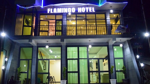 The exterior of the Flamingo Hotel with a prominent sign, large windows, and a staircase leading to the entrance. - Flamingo Guest House (Bahir Dar)