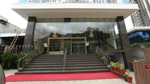 A hotel entrance with a red carpet, steps, and potted plants. - West Fort Hotel (Bengaluru)