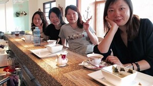 A group of people seated at a counter with various dishes and drinks. - Remember Sea View B&B (Huxi)