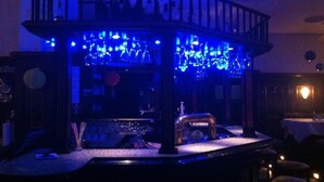 A bar area with a counter, stools, and a railing. - Hotel am Salzberg (Philippsthal)