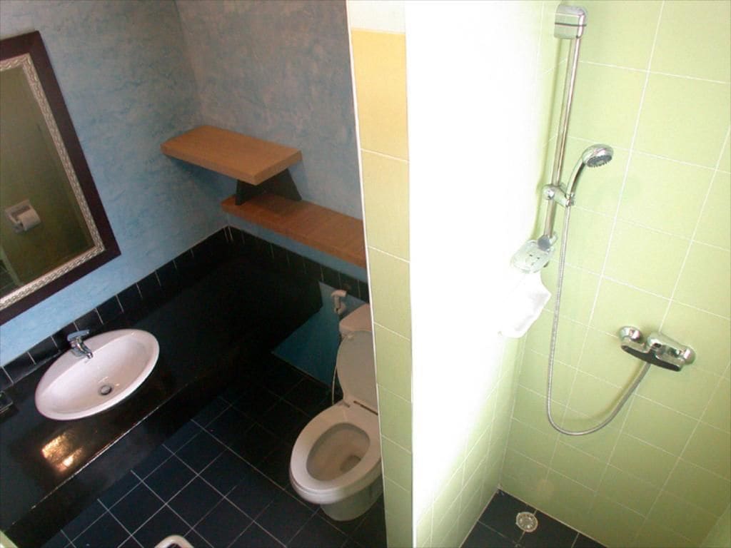 A bathroom with a sink, toilet, and shower.