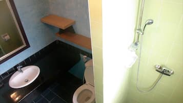 A bathroom with a sink, toilet, and shower.