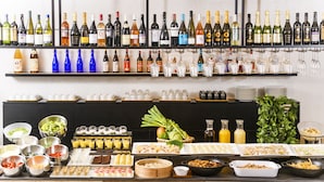 A buffet setup with various food items, beverages, and a wine selection. - Art Hotel Oita (Oita)