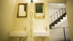 A bathroom with two sinks, a mirror, and a staircase leading to an upper floor. - 176 Together Hostel (Hualien City)