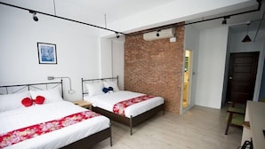 A hotel room with two beds, a brick wall, and a door leading to a balcony. - 176 Together Hostel (Hualien City)