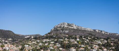 A hillside town with buildings clustered around a rocky hill.