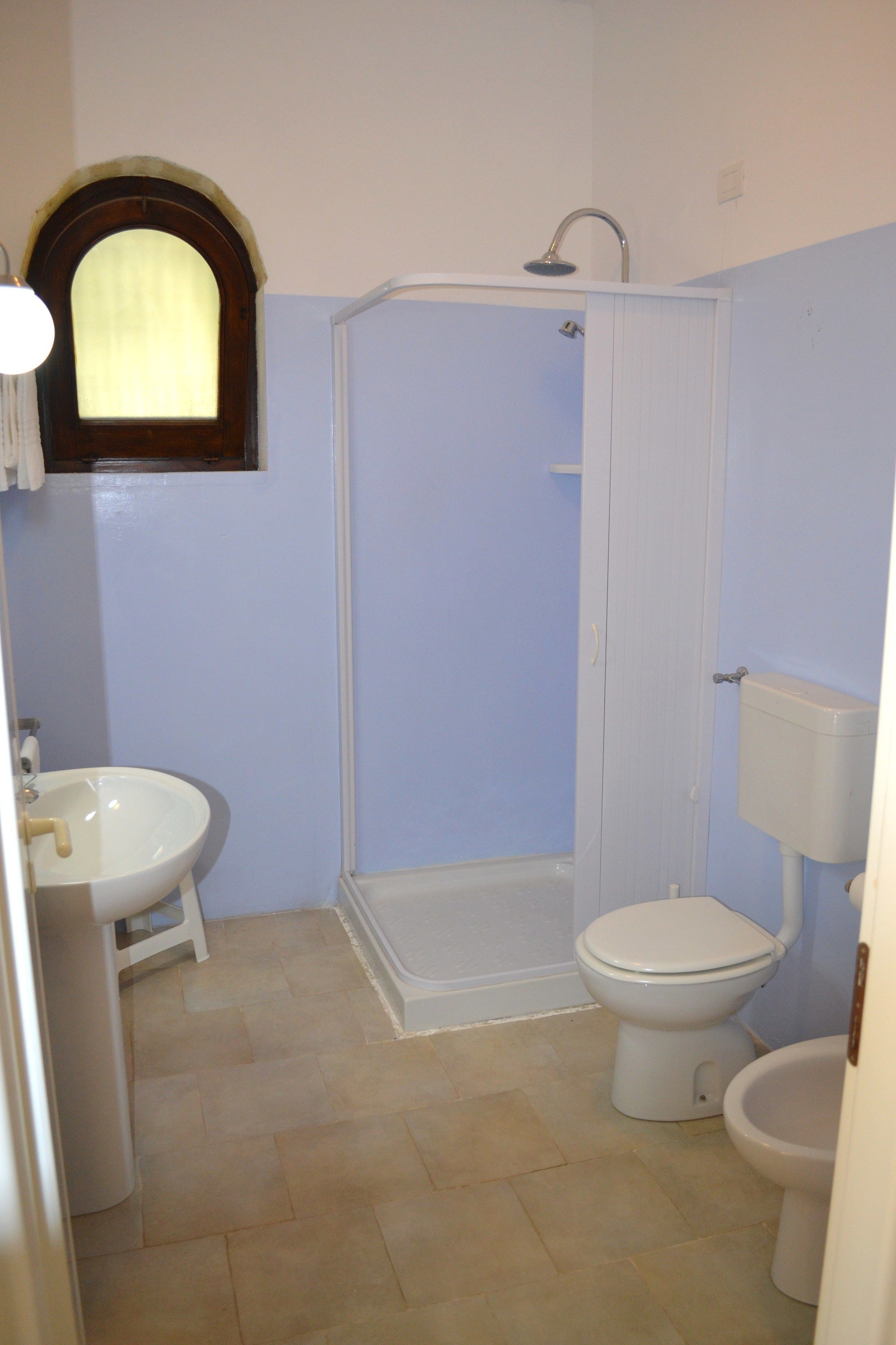A bathroom with a sink, toilet, and shower.