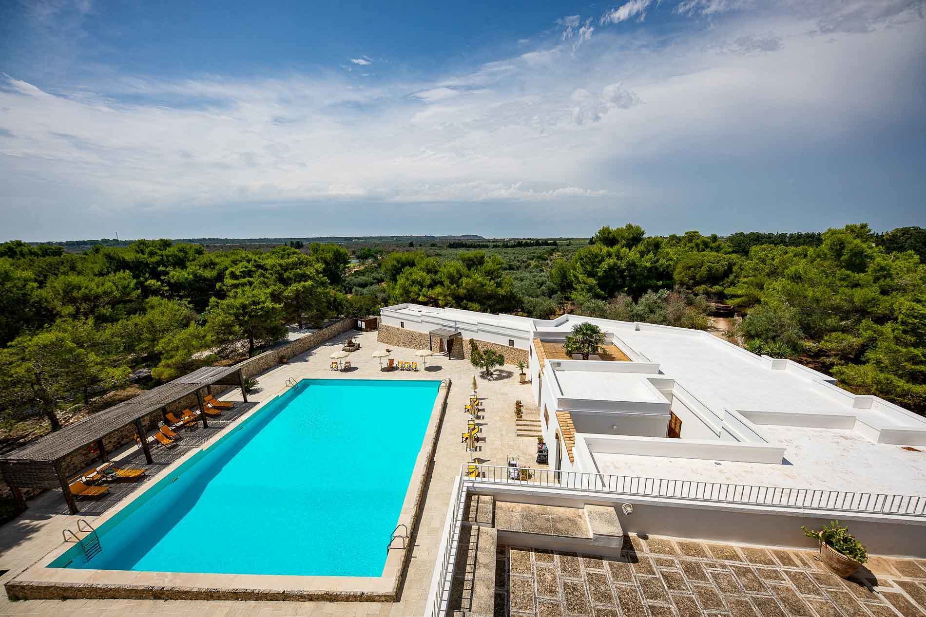 A rooftop swimming pool with a view of the surrounding landscape.