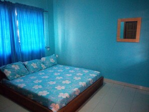 A bedroom with a bed, curtains, a wall-mounted picture frame, and a tiled floor. - Magreth Event Centre & Hotel (Ibadan)