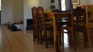 A spacious living area with a high ceiling, a balcony with a yellow railing, and a chandelier. - Quiet villa with pool (Saint Martin de Pallières)