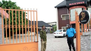 A gated entrance with a sign for 'MAXIMUS' and 'GUINNESS' visible. - Maximus Suites (Lagos)
