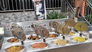 A buffet with various food options in stainless steel containers. - Maximus Suites (Lagos)