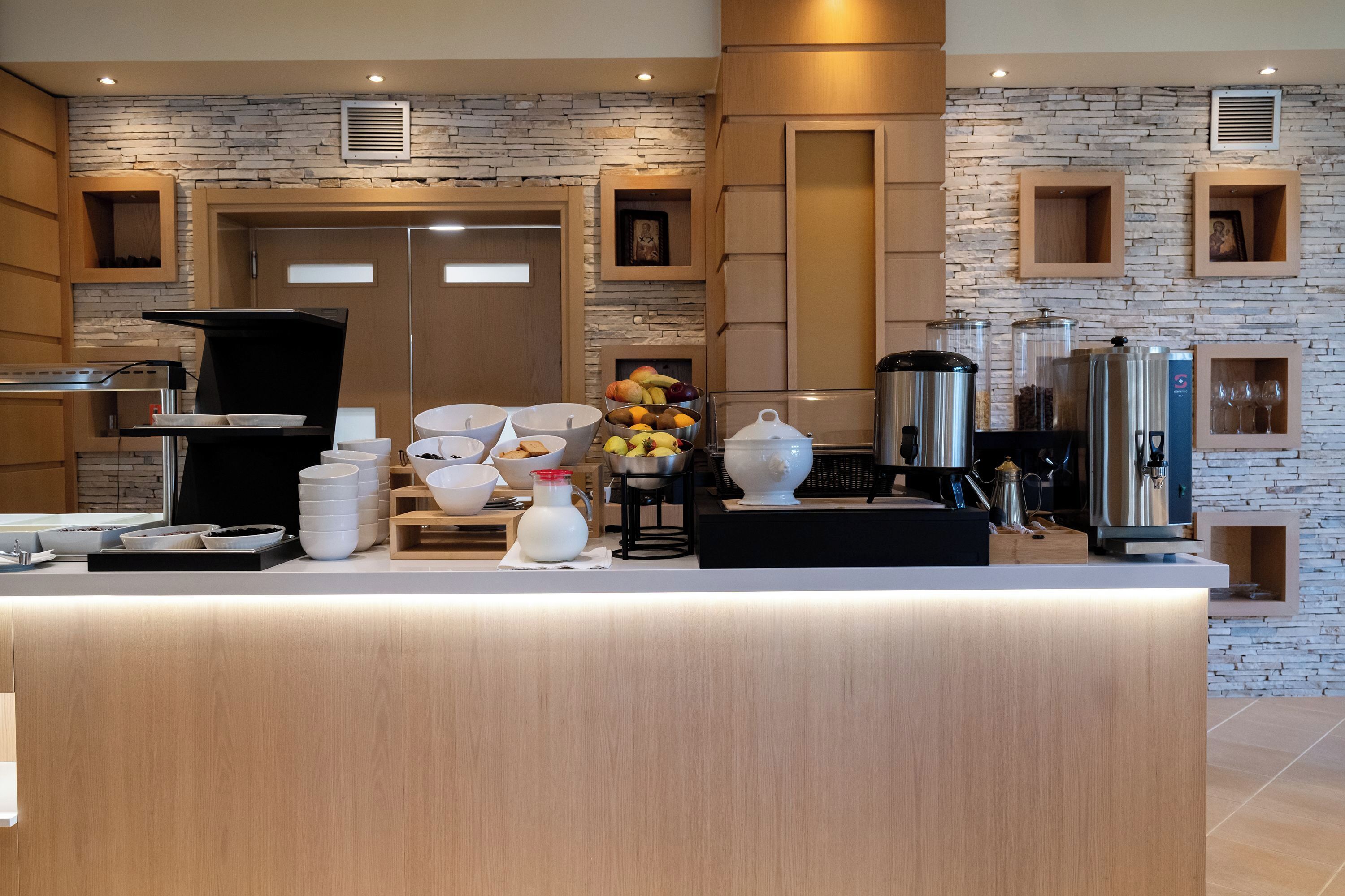 A modern kitchen with a central island, built-in appliances, and a stone accent wall.