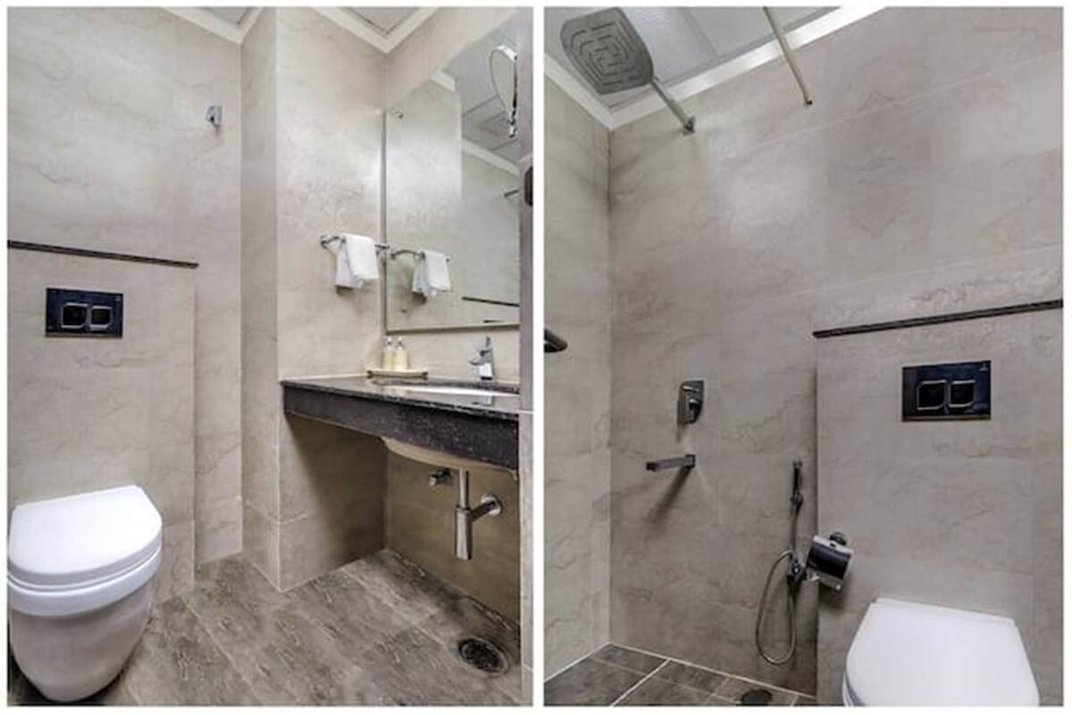 A bathroom with a toilet, sink, and shower.