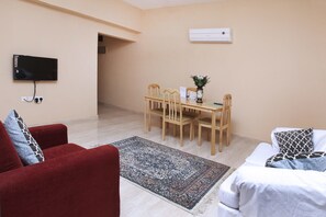 Deluxe Apartment, 1 Bedroom | Living area | 32-inch flat-screen TV with satellite channels, TV