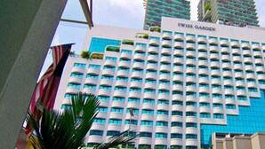A hotel with a modern design, featuring a prominent 'SWISS GARDEN' sign. It has a grid of balconies and a blue facade. - Swiss Garden Apex Suites Bukit Bintang (Kuala Lumpur)