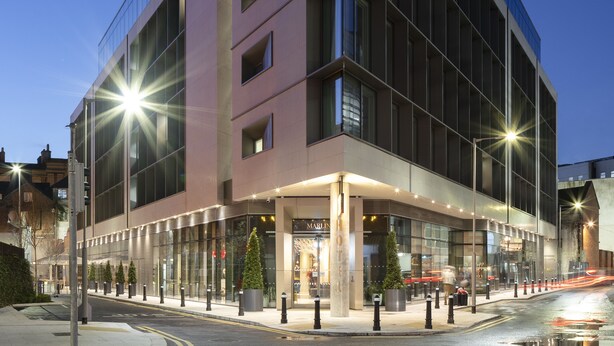 A modern hotel with a glass facade, a well-lit entrance, and a visible reception area. - Marlin Hotel Stephens Green (Dublin)