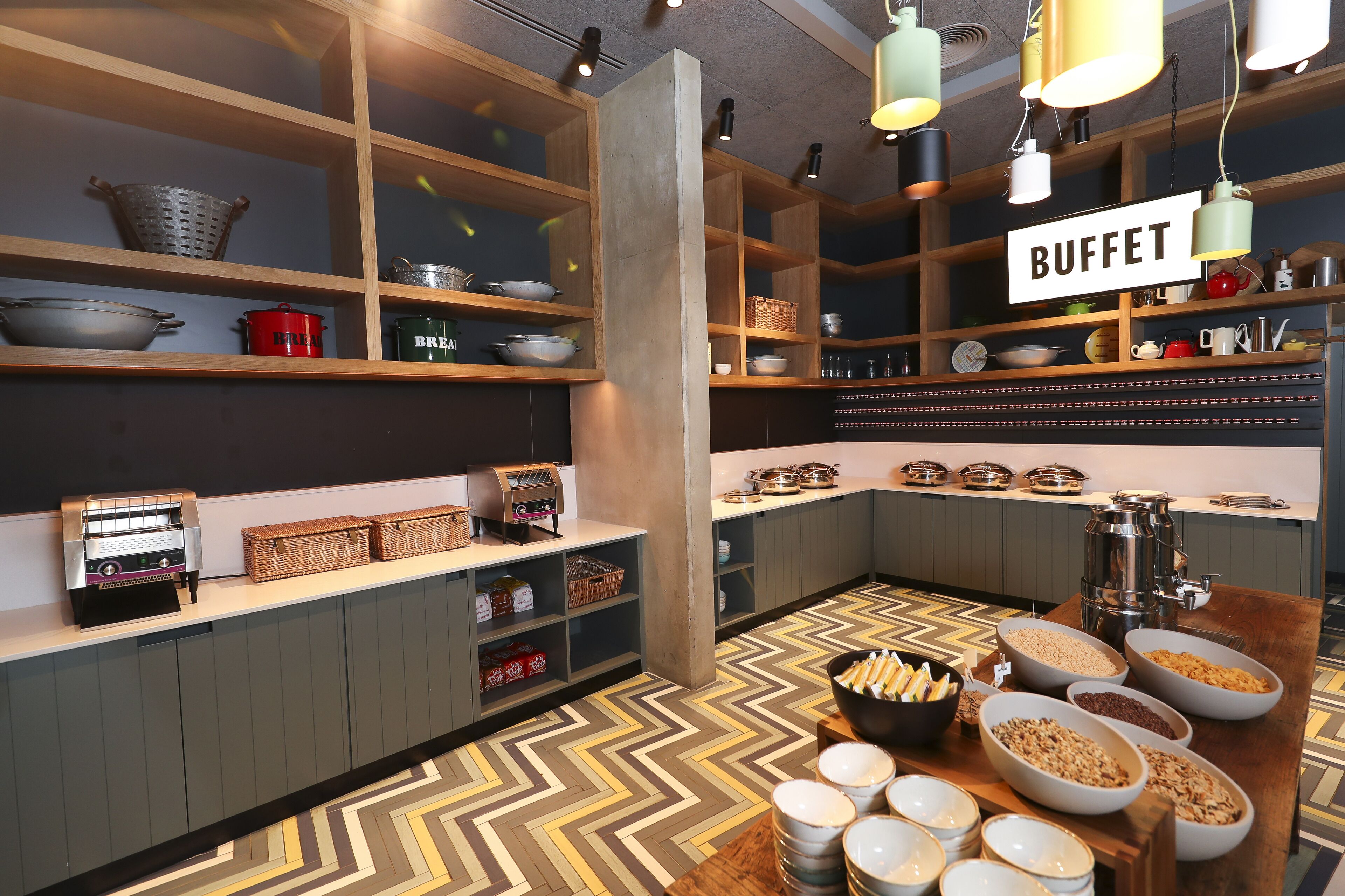 A buffet area with various food bowls and a coffee machine.