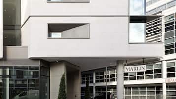 A modern building with a glass facade, a visible entrance, and a sign that reads "MARLIN".